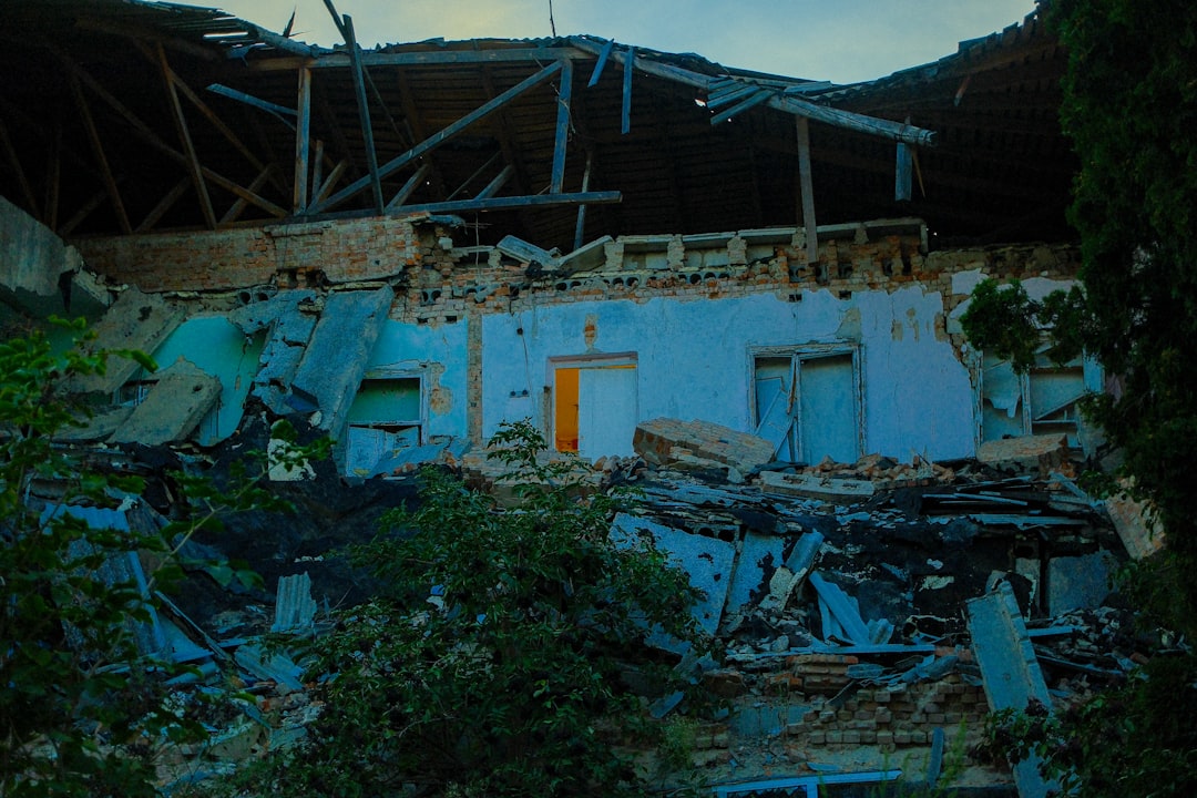 Blue emergency tarp covering a damaged section of roof after a storm