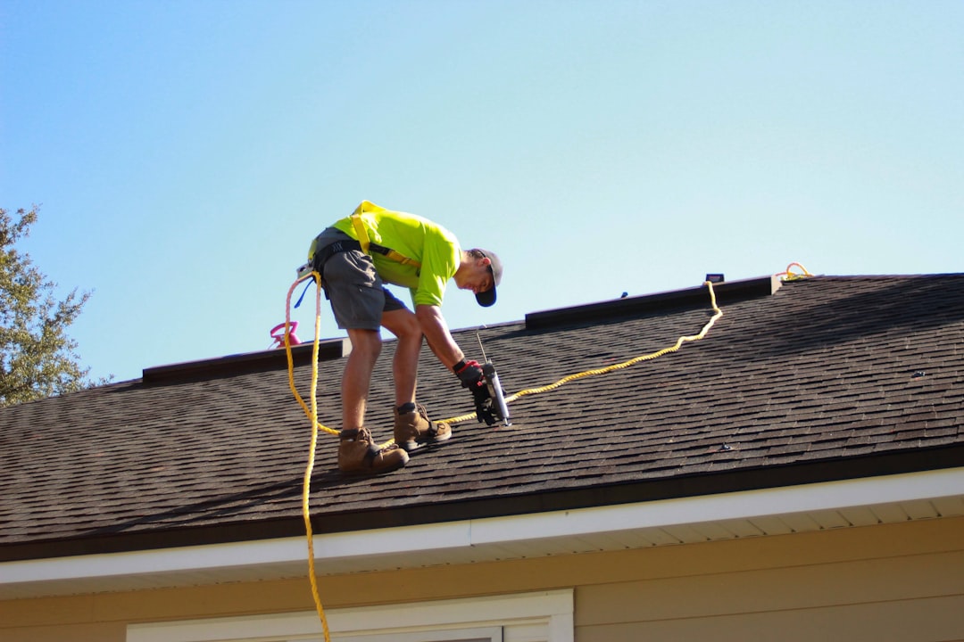 Roofing technician repairing damaged shingles on a Jackson, TN residential roof